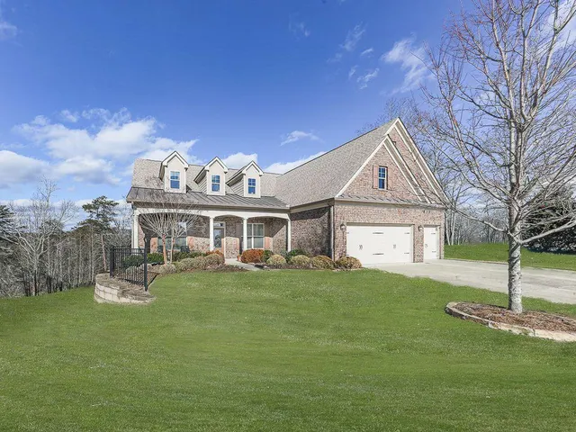 a view of a house with a yard and sitting area