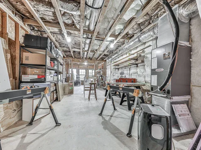 a view of a patio with a dining table and chairs with two plants