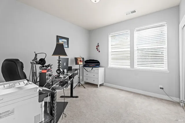 a view of a workspace with furniture and a window