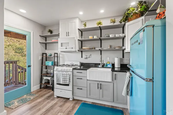 a kitchen with stainless steel appliances granite countertop a stove and a refrigerator