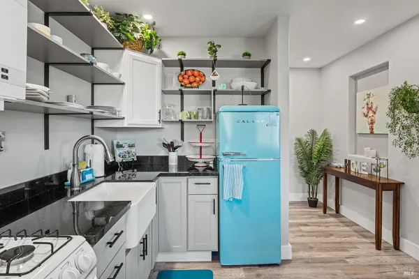 a kitchen with stainless steel appliances granite countertop a refrigerator and a stove