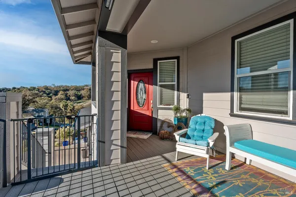 a balcony with furniture and a potted plant