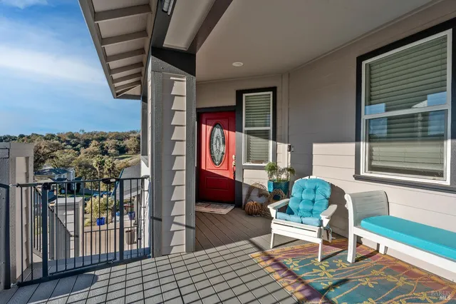 a balcony with furniture and a potted plant