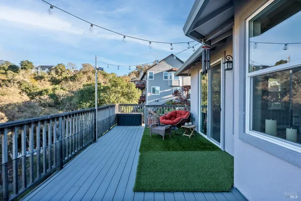 a view of a wooden balcony with outdoor seating