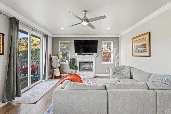 a living room with furniture a fireplace and a flat screen tv