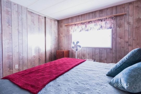 716 West Reeves Avenue Ridgecrest, CA 93555 - Photo 18 of 28 a bed sitting in a bedroom next to a window