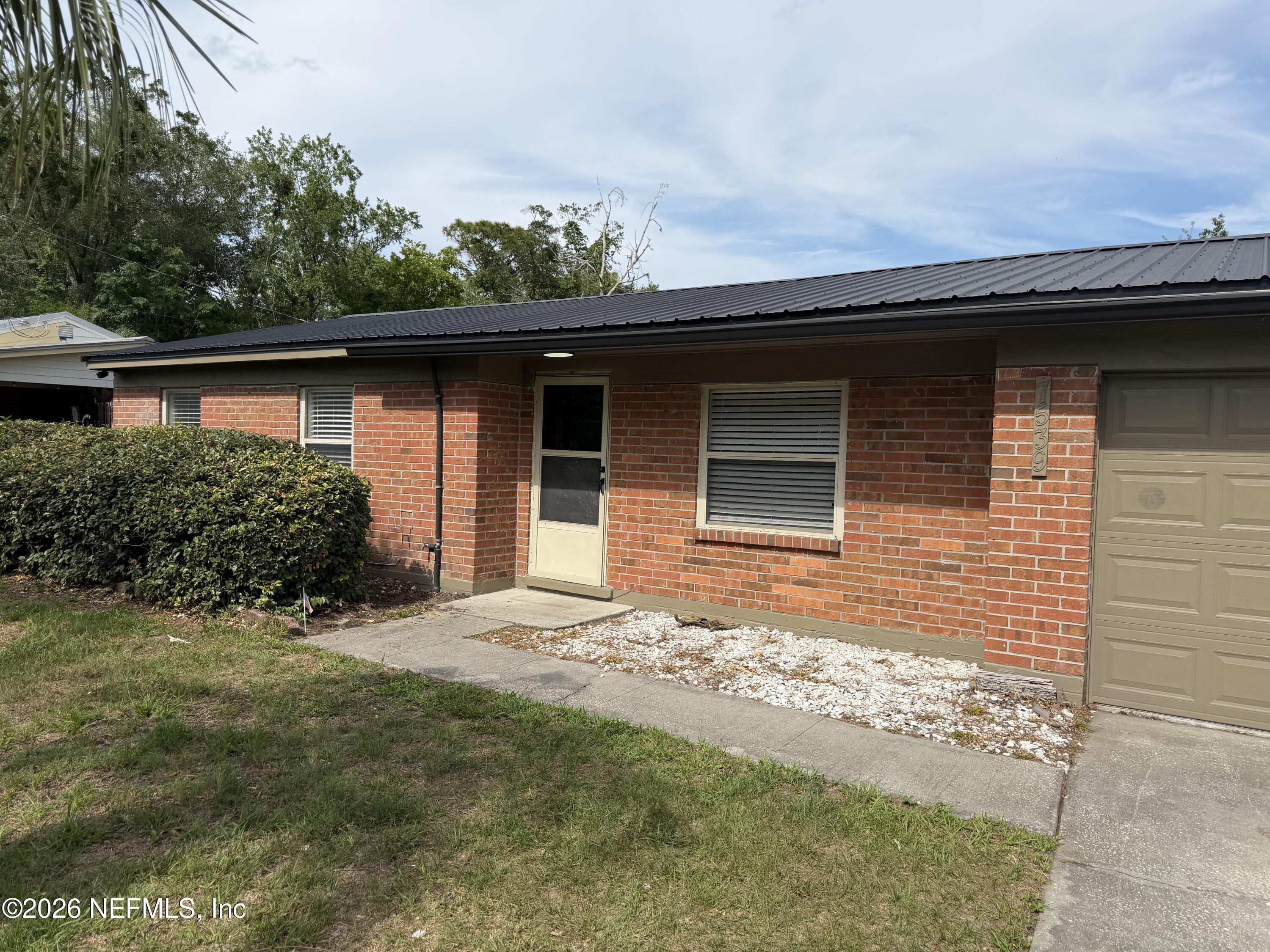 7539 Walden Road Jacksonville, FL 32244 - Photo 1 of 18 a front view of a house with a yard