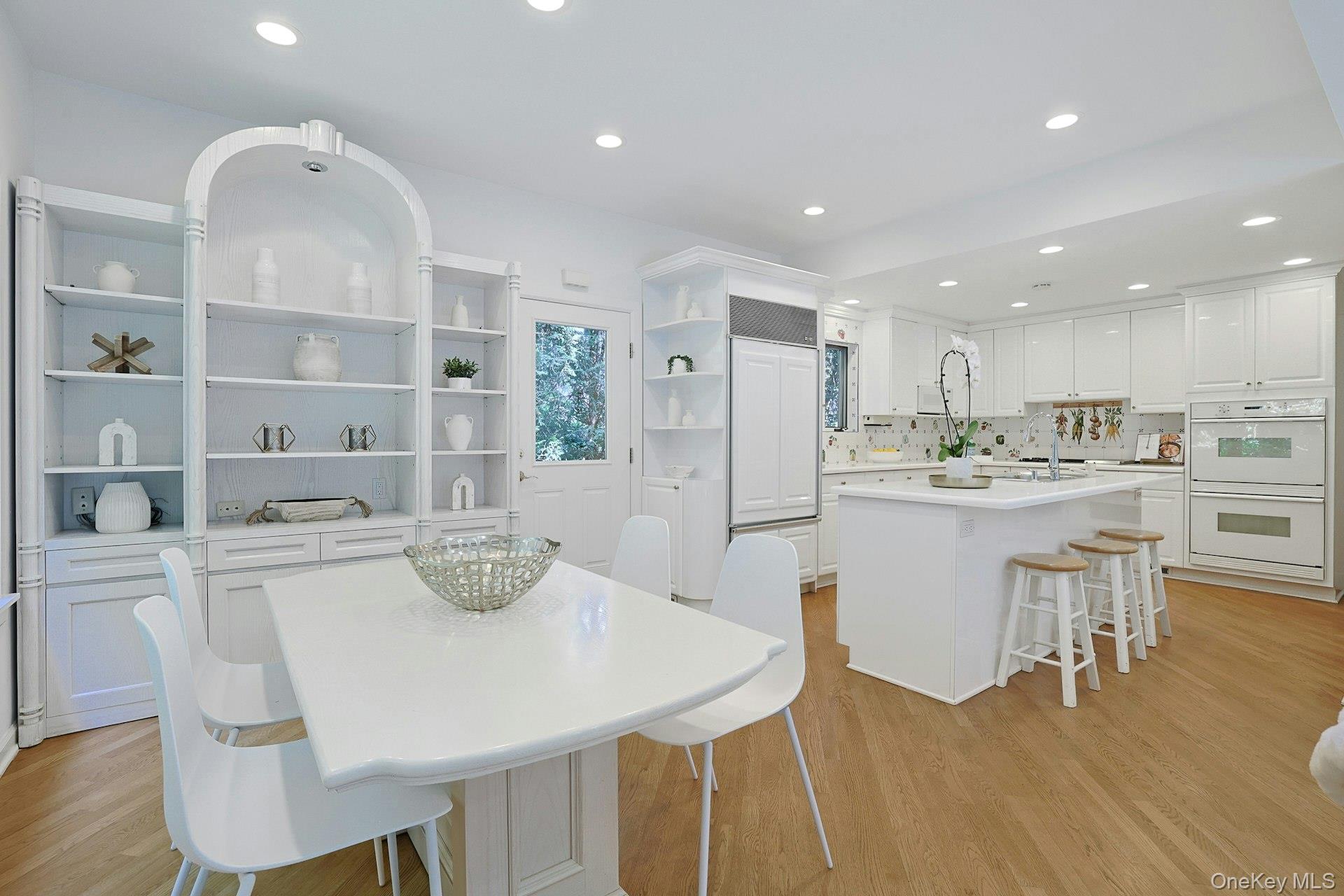 17 Elm Road Scarsdale, NY 10583 - Photo 12 of 38 A generous breakfast area with custom built-in cabinetry offers a relaxed setting for everyday dining just steps from the kitchen.