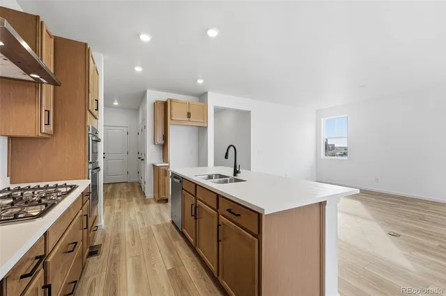 a view of a kitchen with wooden floor and a sink