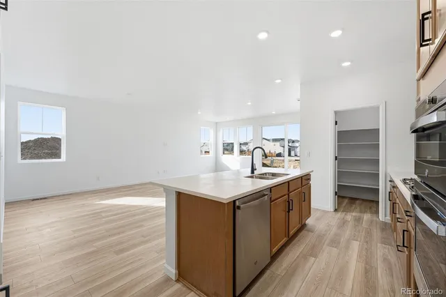 a kitchen with a sink stove and cabinets