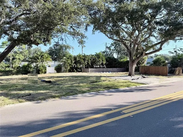 a view of a street with a house in the background
