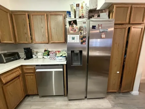 a kitchen with stainless steel appliances granite countertop a refrigerator a sink and a stove