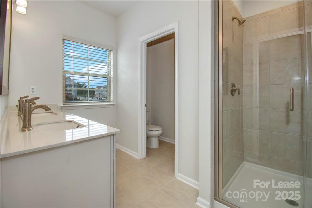 3130 Glenn Hope Way Matthews, NC 28104 - Photo 12 of 24 a bathroom with a granite countertop sink toilet and shower