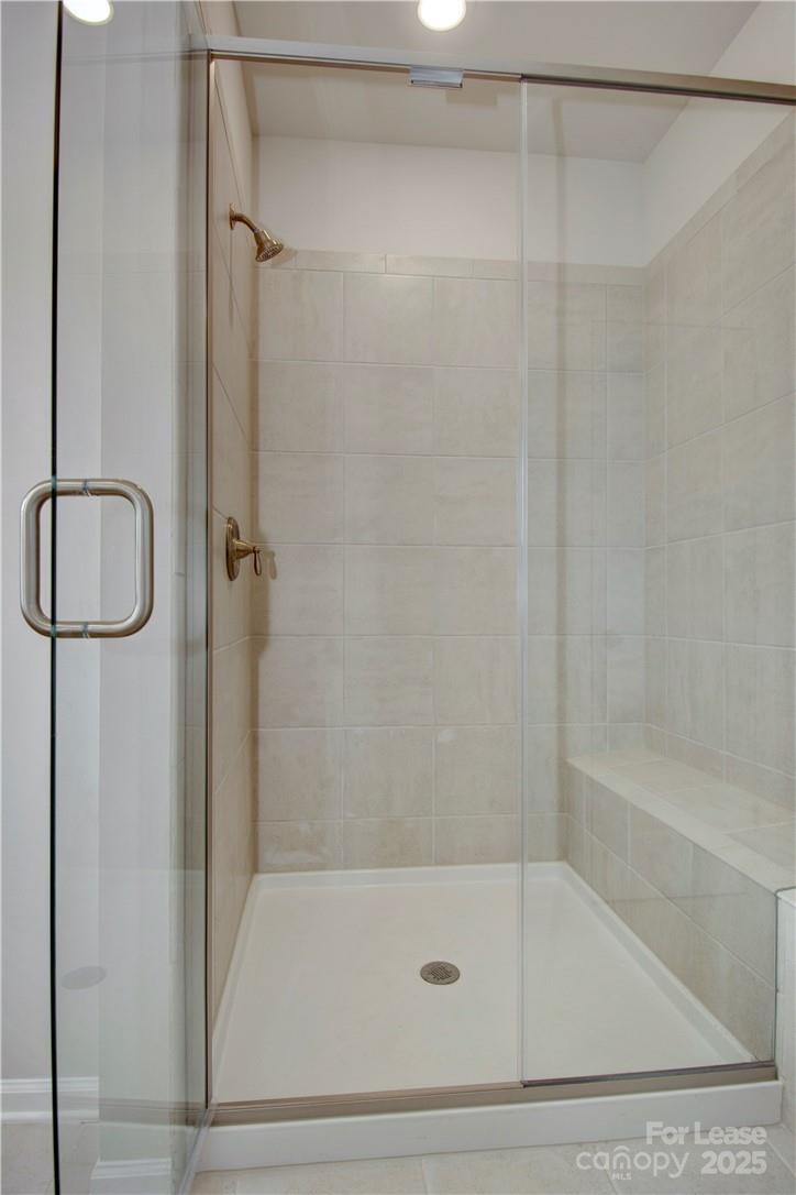 3130 Glenn Hope Way Matthews, NC 28104 - Photo 13 of 24 a bathroom with a bathtub and a shower
