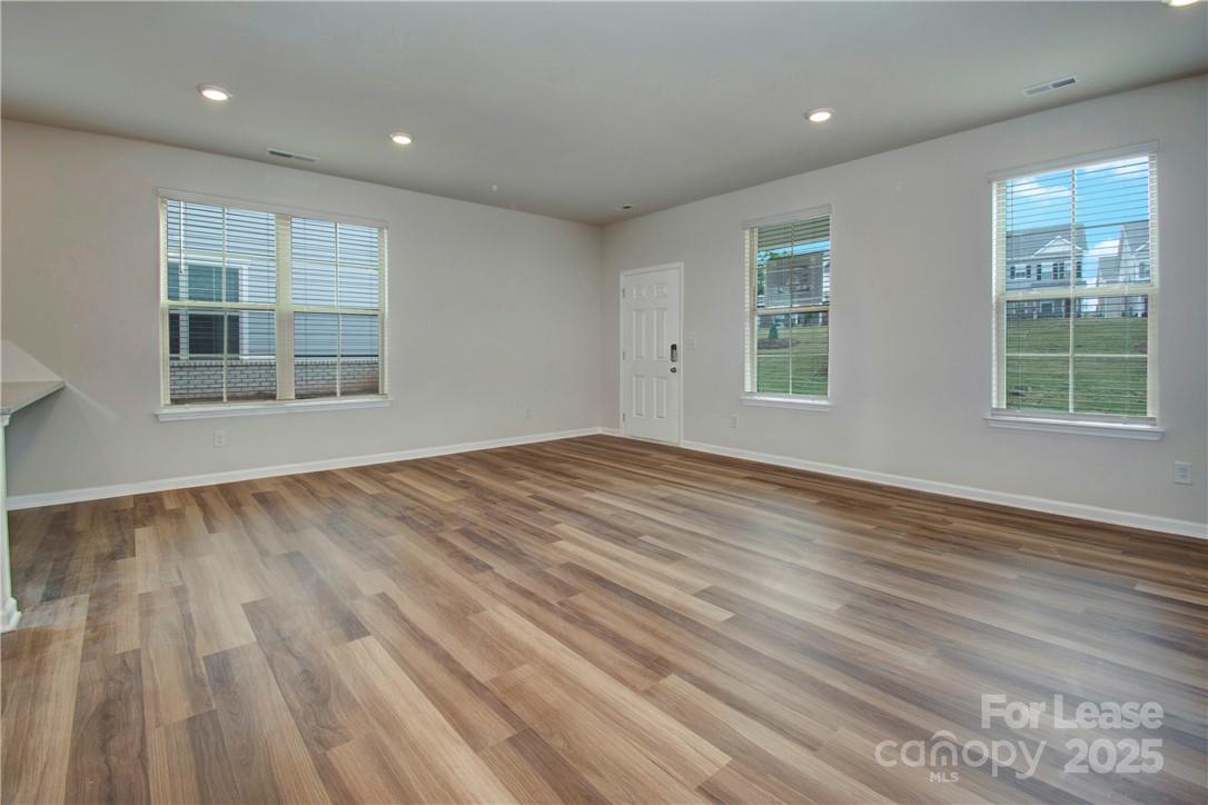 3130 Glenn Hope Way Matthews, NC 28104 - Photo 3 of 24 an empty room with wooden floor and windows