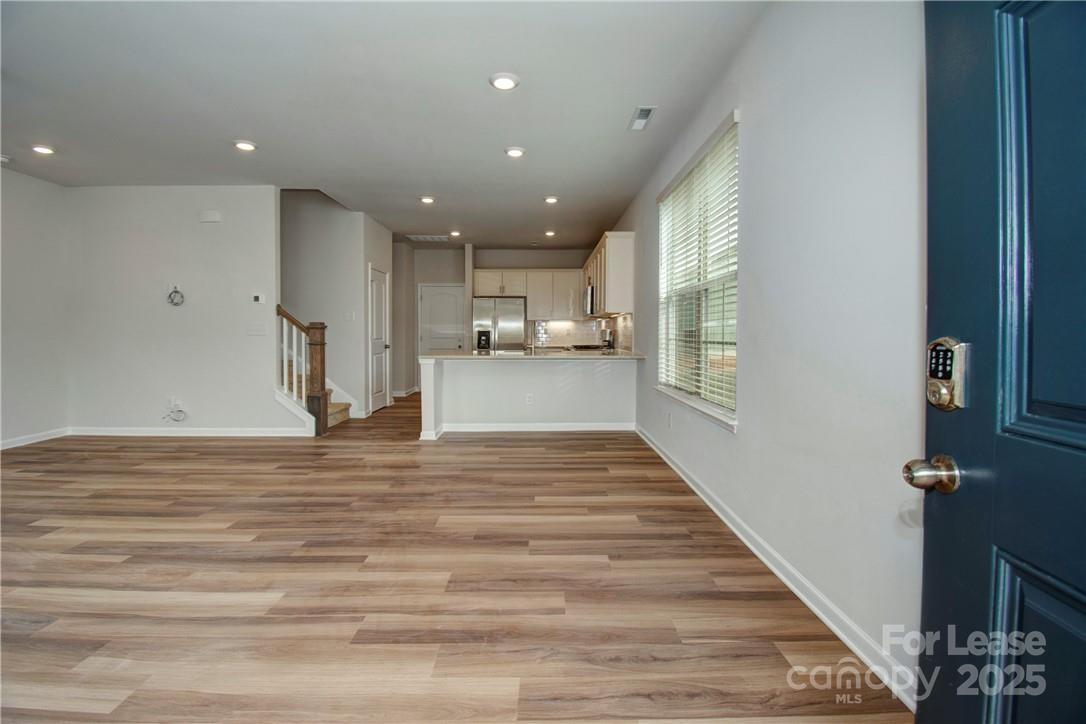 3130 Glenn Hope Way Matthews, NC 28104 - Photo 4 of 24 a view of a living room and kitchen with a wooden floor