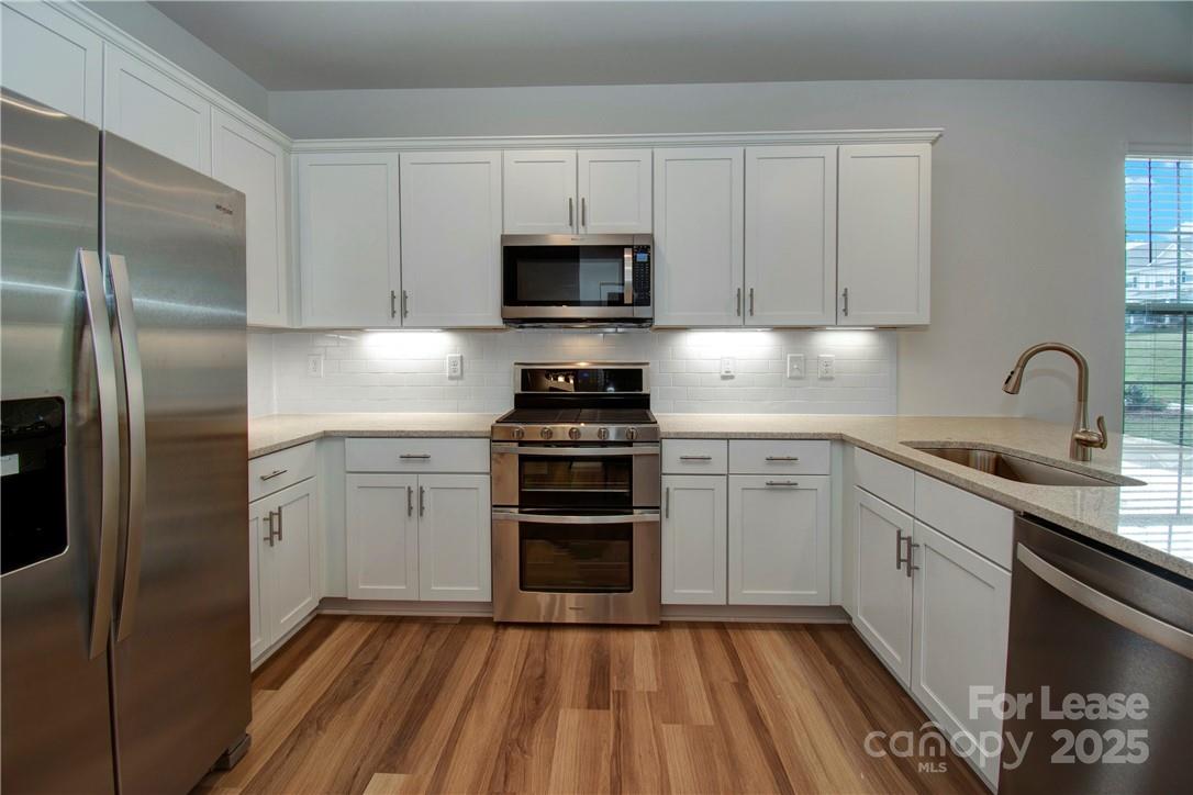 3130 Glenn Hope Way Matthews, NC 28104 - Photo 6 of 24 a kitchen with cabinets stainless steel appliances and a sink