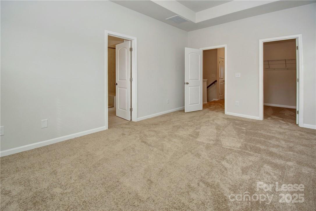3130 Glenn Hope Way Matthews, NC 28104 - Photo 10 of 24 an empty room with closet and wooden door
