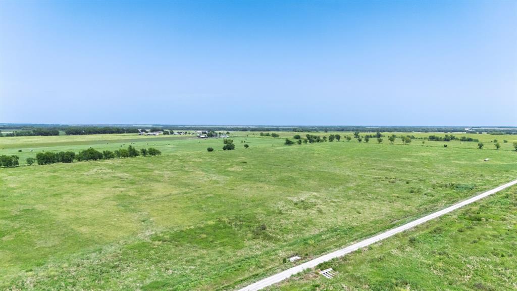 Lot 9 County Line Road Pecan Gap, TX 75469 - Photo 2 of 10 a view of a green field with clear sky