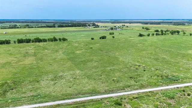 a view of a field with an ocean beach
