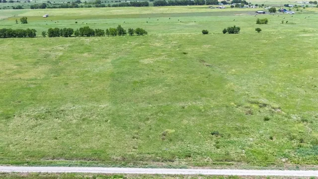 a view of a green field with clear sky