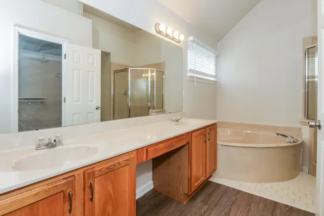 a bath room with a sink and a large mirror