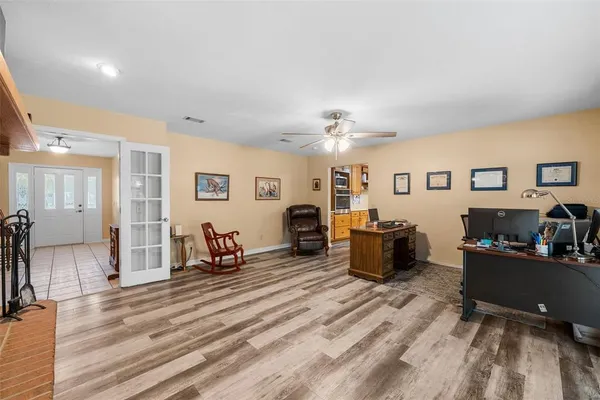 a living room with furniture and wooden floor