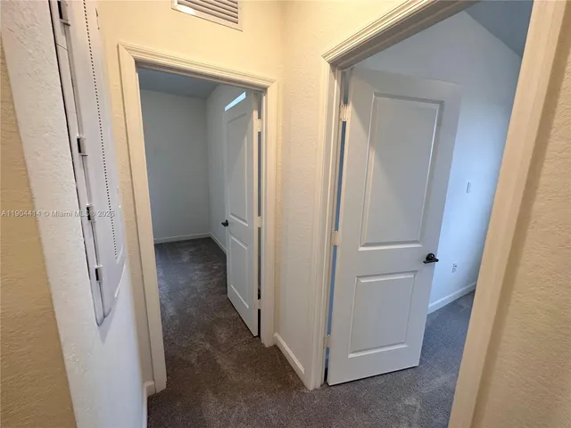 a view of a bathroom from a hallway