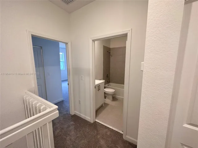 a view of a bathroom from a hallway