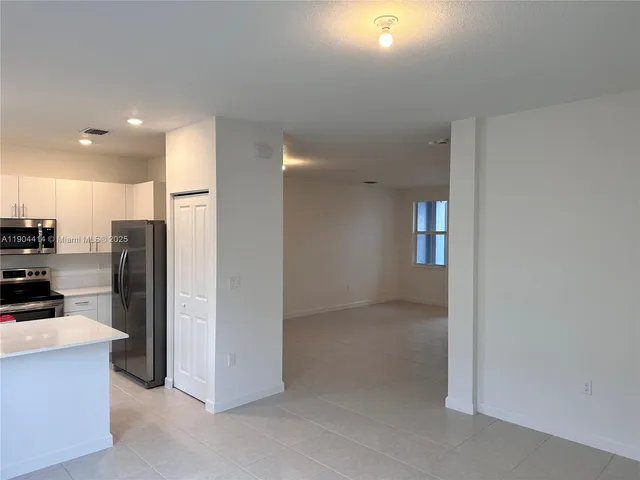 a view of a kitchen with a refrigerator and a stove
