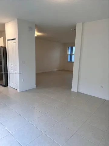 an empty room with an entryway and fireplace