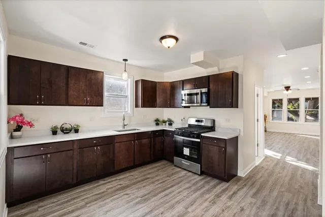 a kitchen with stainless steel appliances kitchen island granite countertop a sink and cabinets