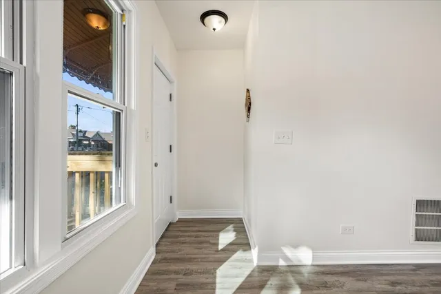 a view of a livingroom with wooden floor and a window