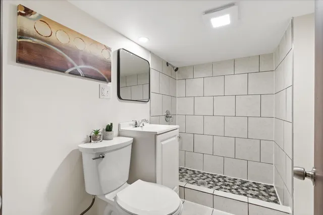 a bathroom with a toilet sink and shower