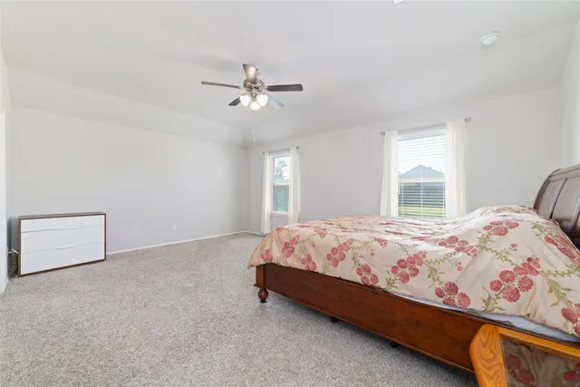 a bed sitting in a bedroom next to a window