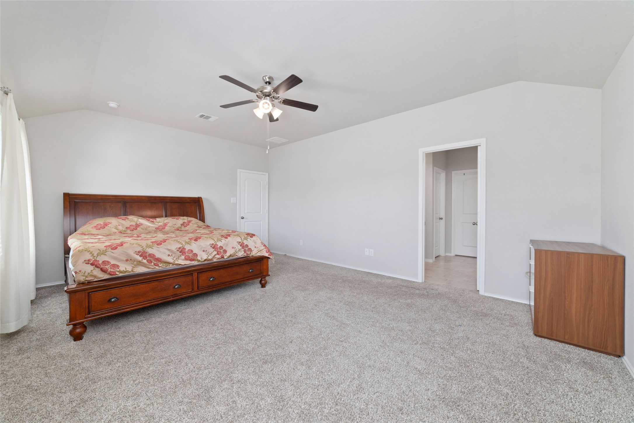24323 Winchelsea Lane Spring, TX 77389 - Photo 13 of 24 a bedroom with a bed and a chandelier