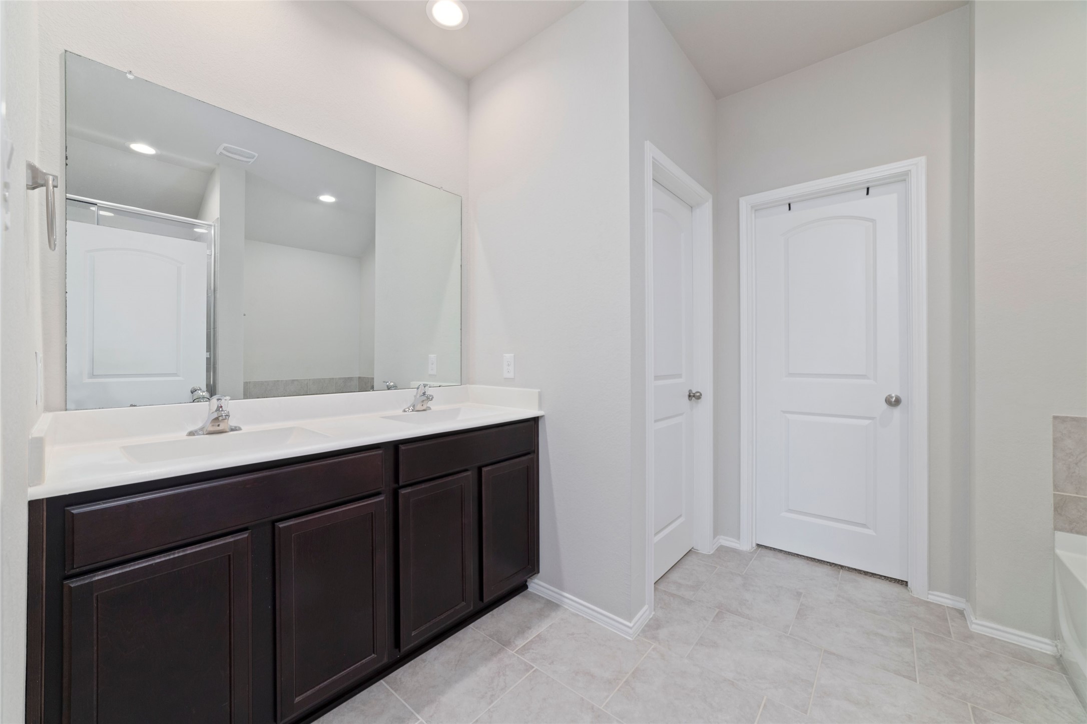 24323 Winchelsea Lane Spring, TX 77389 - Photo 14 of 24 a bathroom with a double vanity sink and mirror