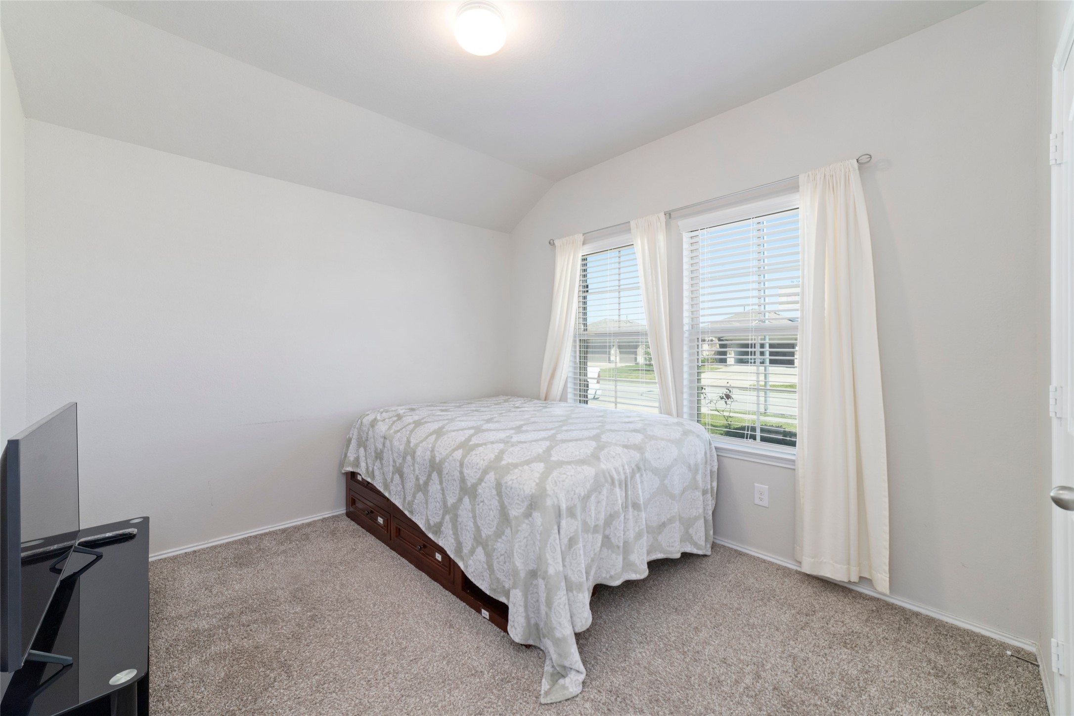 24323 Winchelsea Lane Spring, TX 77389 - Photo 17 of 24 a bed sitting in a bedroom next to a window