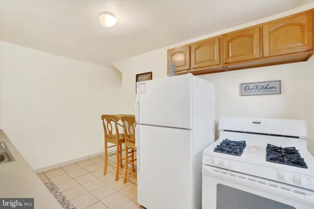 a white refrigerator freezer sitting inside of a kitchen
