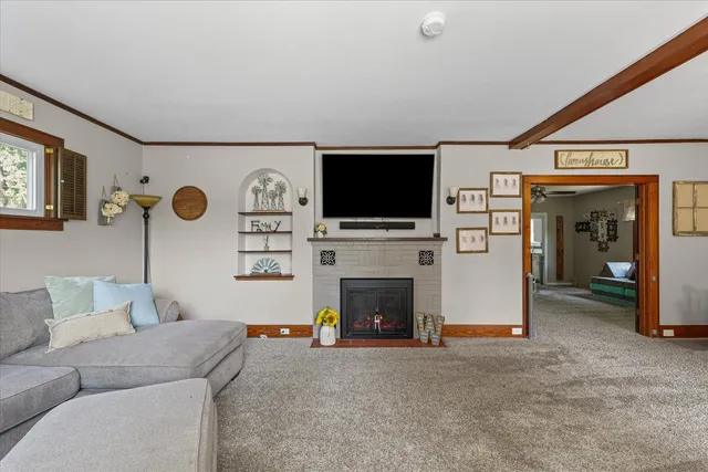 a living room with fireplace furniture and a flat screen tv