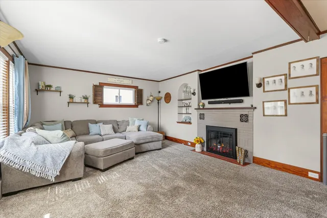 a bedroom with a bed and a flat tv screen on dresser