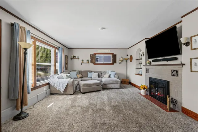 a living room with furniture and a fireplace