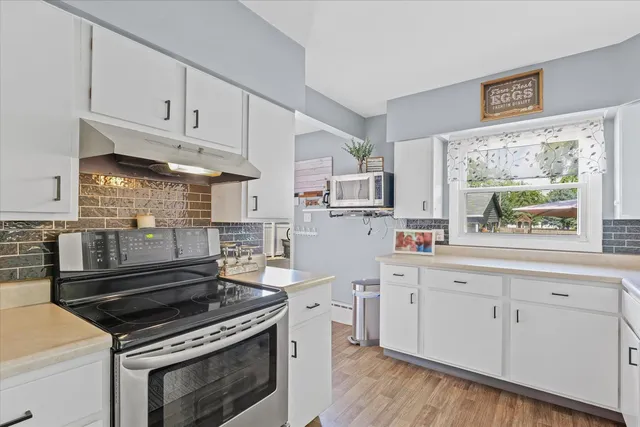 a kitchen with stainless steel appliances a sink stove and refrigerator