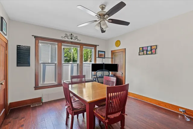 a view of a dining room with furniture window and wooden floor