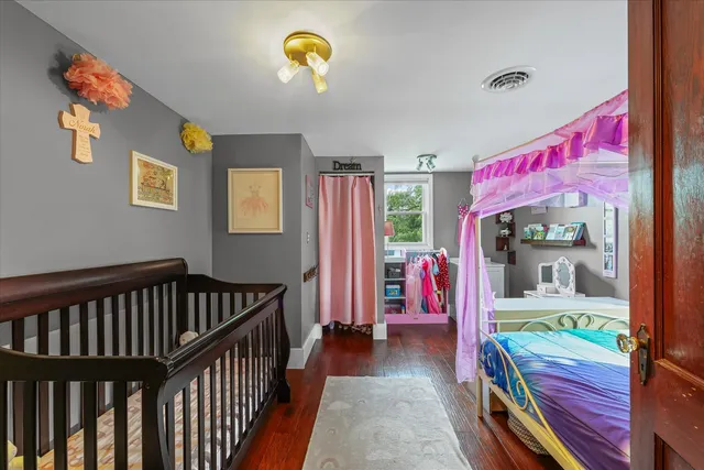 a bedroom with a bed and a baby crib