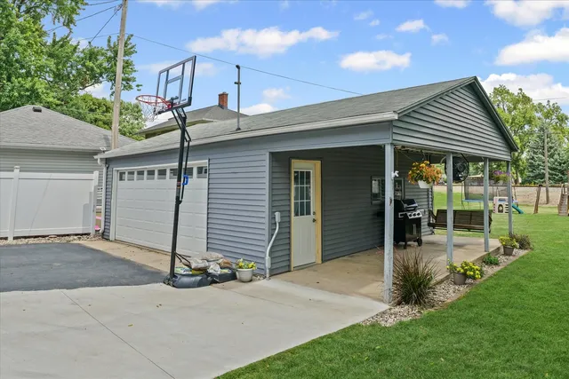 a front view of a house with a garden and plants