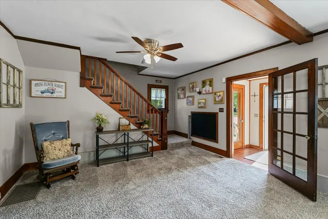 a view of an empty room with furniture and a ceiling fan