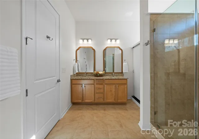 a bathroom with a double vanity sink and mirror