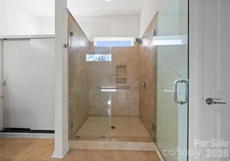 a bathroom with a glass shower door