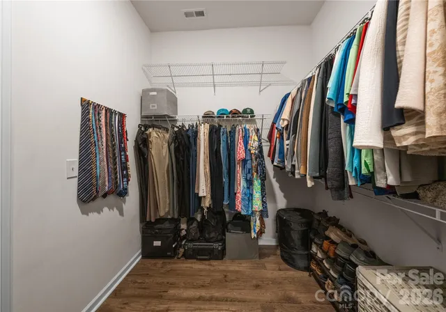a view of walk in closet with clothes